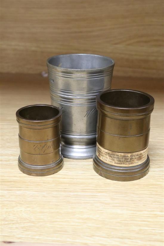 Two late 18th century bronze measures, Gill and Half Gill, and a 19th century pewter half-pint tavern pot